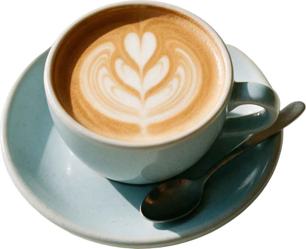 A fresh flat white with a rosetta in the crema, on a pale blue saucer.